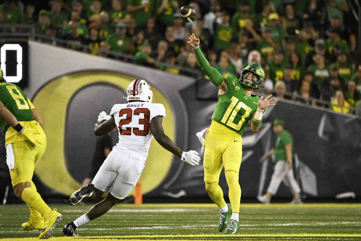 Oct 1, 2022; Eugene, Oregon, USA; Oregon Ducks quarterback Bo Nix (10) throws a pass during the first half against Stanford Cardinal defensive end David Bailey (23) at Autzen Stadium. Mandatory Credit: Troy Wayrynen-USA TODAY Sports